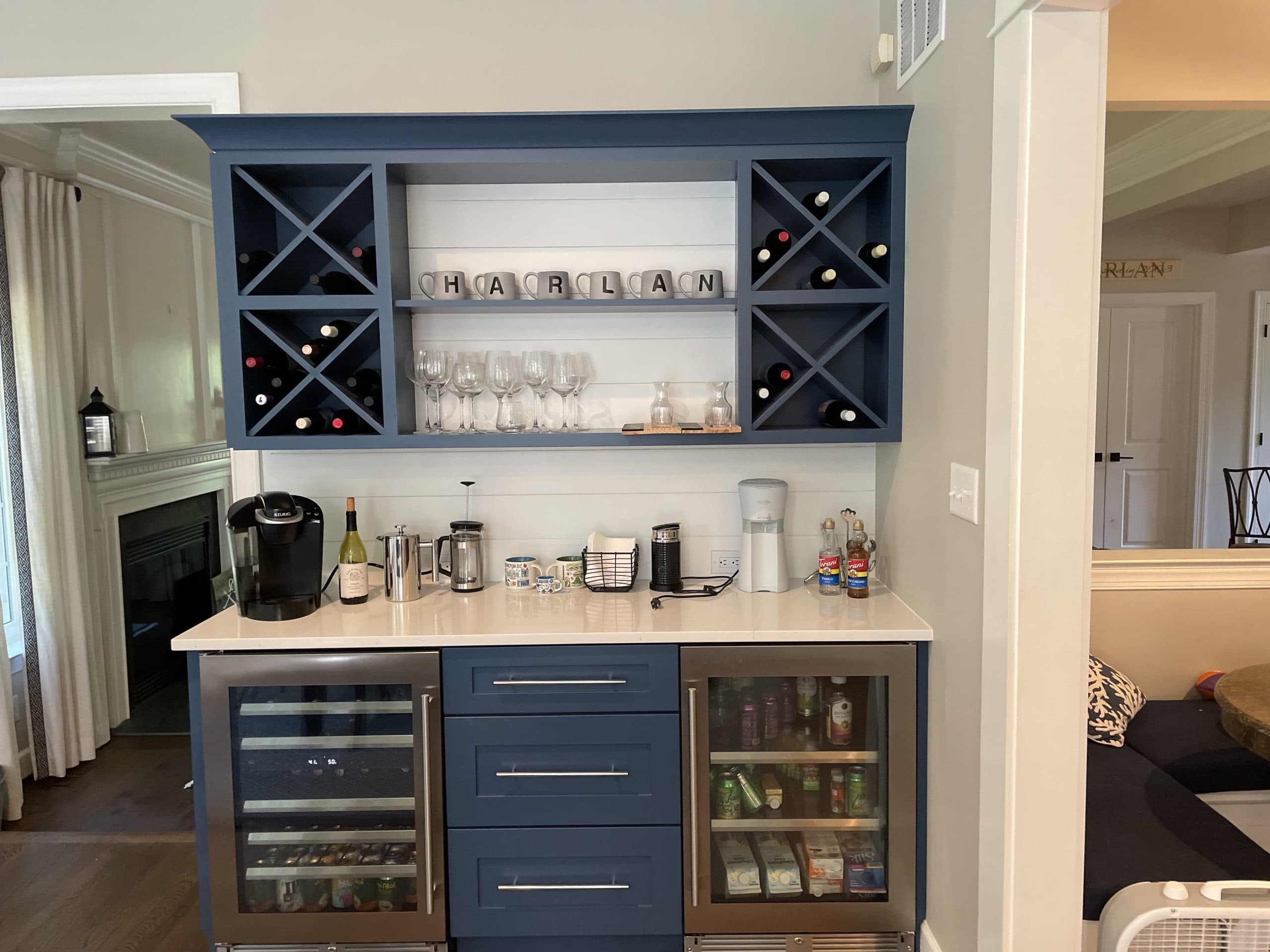 Custom built-in bar and coffee station with navy cabinetry and wine storage by Harlan Custom Contracting