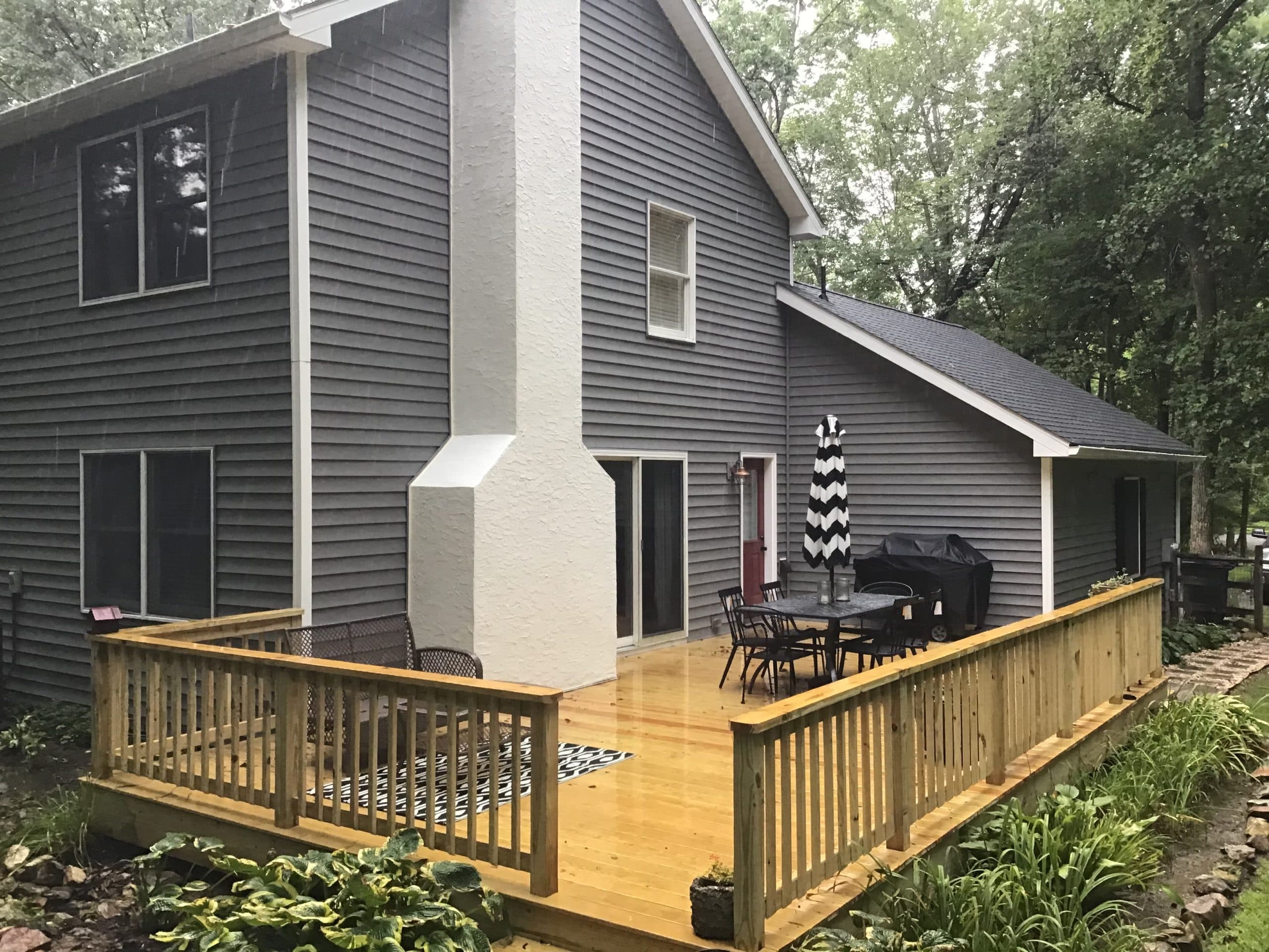 New pressure-treated wood deck with custom railings built by Harlan Custom Contracting